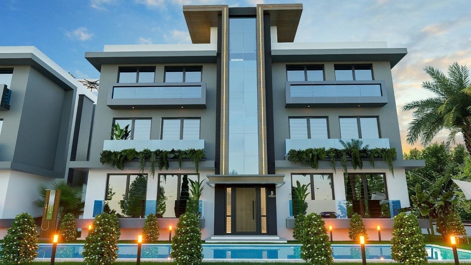A Grand Lapta residence at dusk with the pool in front