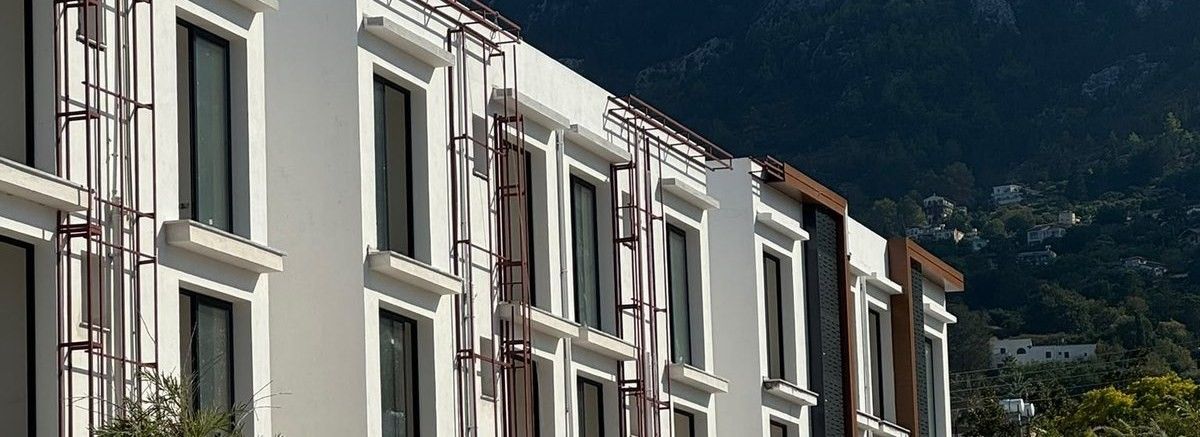 Finished building facades with the mountains behind